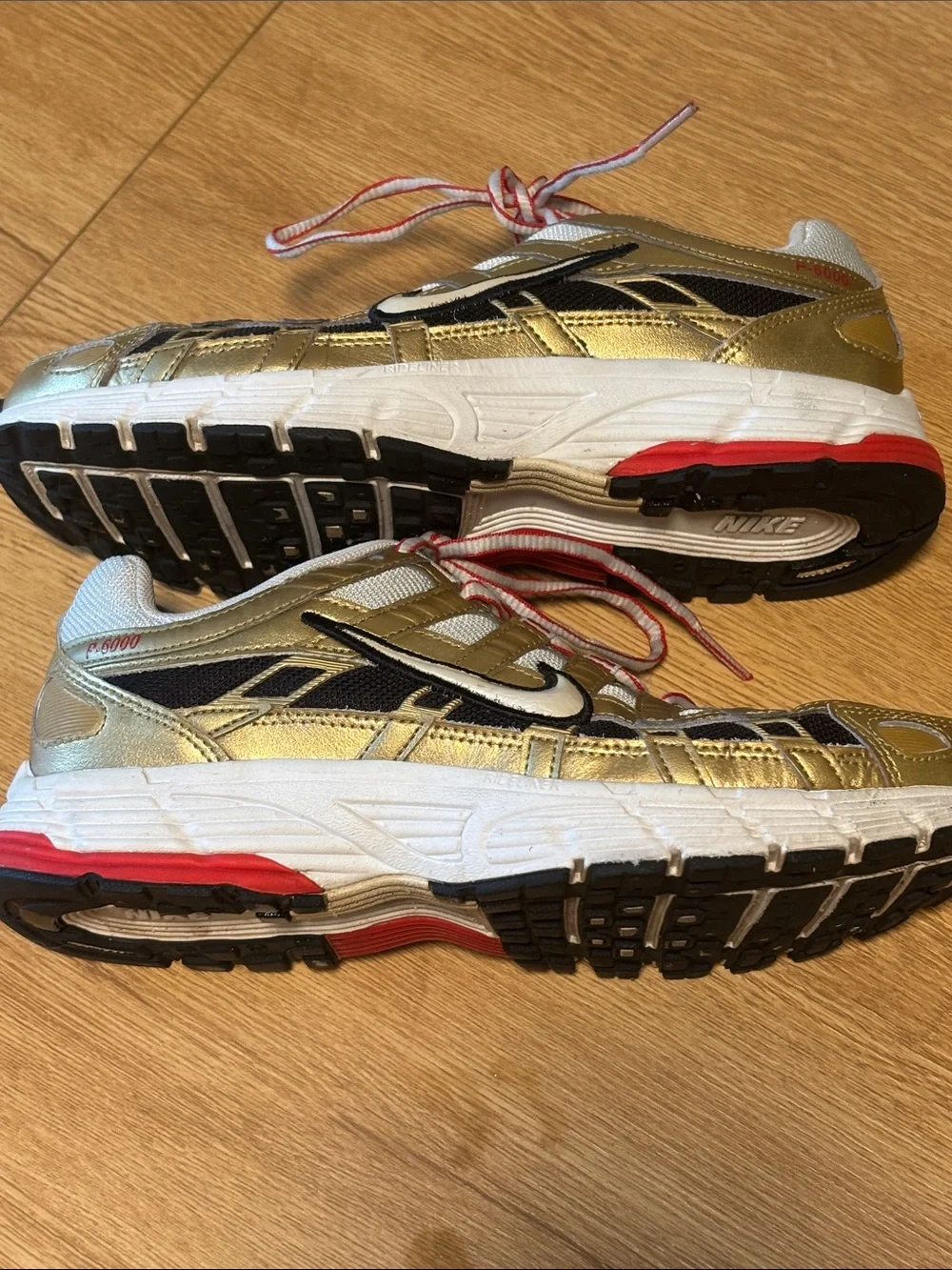 Nike BOWERMAN Metallic Gold, White & Black Athletic Sneakers with Red Details